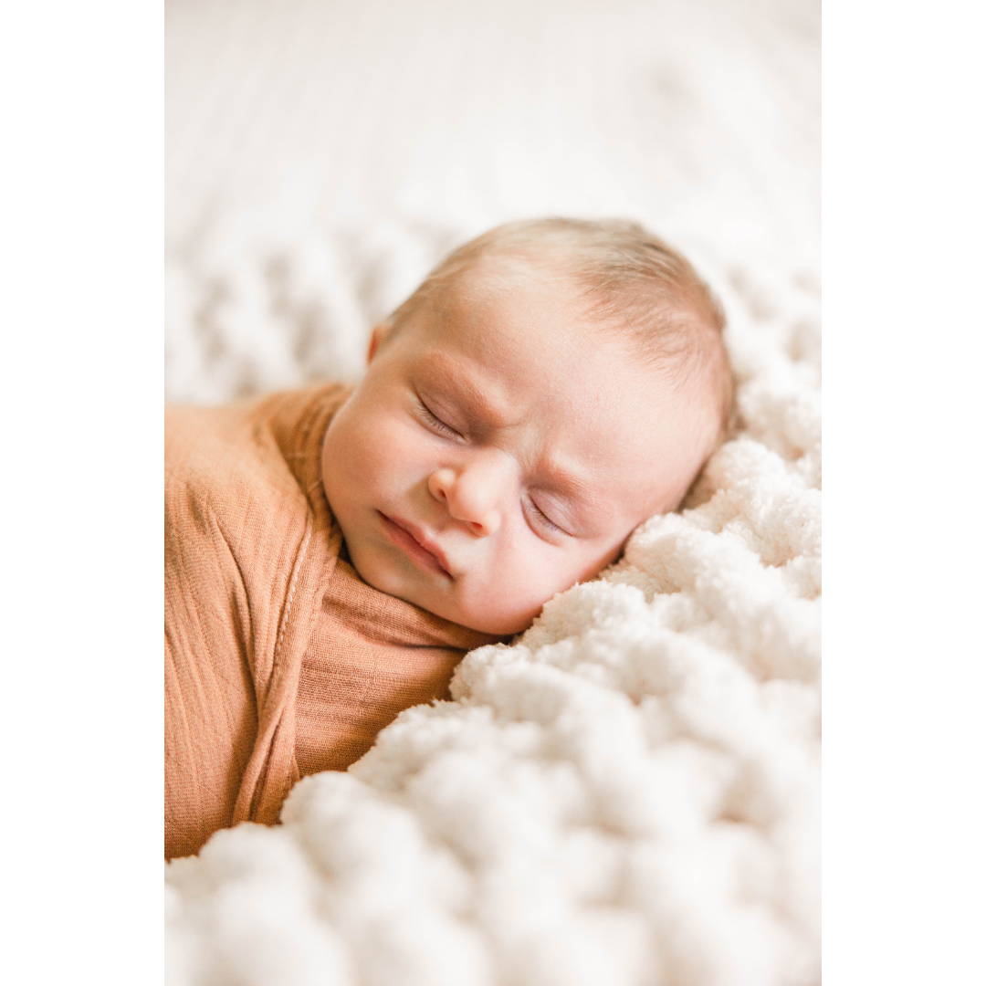 Close-up of newborn baby all swaddled and cozy during in-home photo session in Howell, Michigan.
